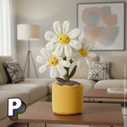 Peluche pot de Marguerites en fleurs Amuseables de Jellycat sur une table basse dans un salon